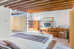 a bedroom with a large bed and a desk at Historic House in Mallorca Up To 12 Guests in Andratx