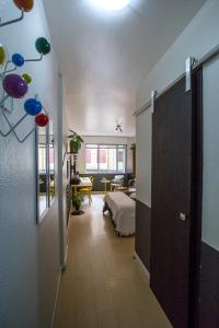 a room with a bedroom with a bed and a living room at Meu lugar na Cidade Baixa in Porto Alegre