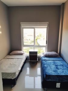 A bed or beds in a room at Melhor Condomínio Villas no Campeche