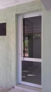 a door with a window on the side of a building at El Balcón 2 in Concepción del Uruguay