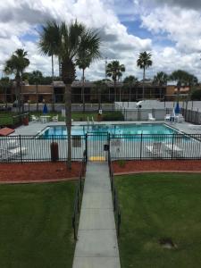 a swimming pool in a park with a fence at Days Inn by Wyndham St Augustine I-95-Outlet Mall in St. Augustine