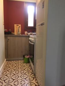 a kitchen with a white refrigerator and a kitchen floor at Acropolis Apartment in Athens