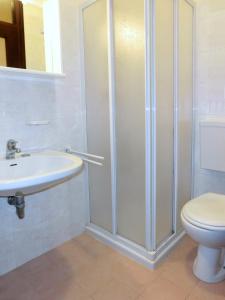 a bathroom with a shower and a toilet and a sink at Tra i Pini in Lignano Sabbiadoro