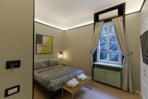 a bedroom with a bed and a window at Destil B&B in Tirana