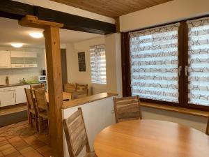 a kitchen and dining room with a wooden table and chairs at AB Apartment Objekt 122 in Uhingen +33 photos