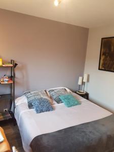 a bedroom with a bed with two pillows on it at Home St. Germain in Trouville-sur-Mer