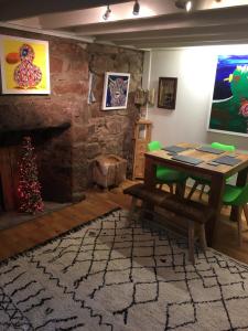 a living room with a table and a christmas tree at Dunnottar Cottage in Stonehaven