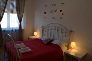 a bedroom with a bed with hearts on the wall at Night & Day in Pisa