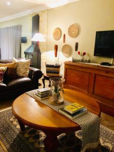 a living room with a couch and a coffee table at 11 Protea in Knysna
