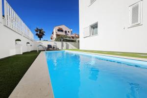 a swimming pool in the backyard of a house at Villa DOEL in Zadar