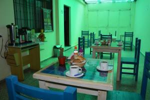 a table in a room with two tables and chairs at Hostal Bernardo Salta in Salta