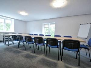 einen Konferenzraum mit einem Tisch und Stühlen in einem Klassenzimmer in der Unterkunft GOŚCINIEC NAD SAWĄ in Handzlówka