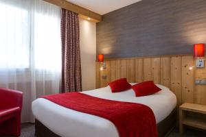 a bedroom with a large bed with a red blanket at The Originals City, Hôtel Rey du Mont Sion, Saint-Julien-en-Genevois Sud (Inter-Hotel) in Saint-Blaise