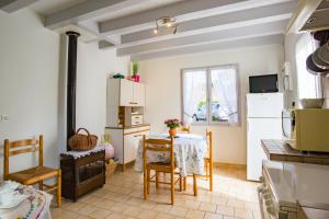 a kitchen with a table and chairs in a room at Maison Lous Amics in Orx