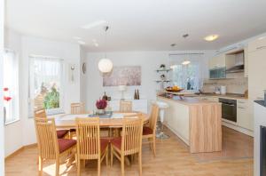 a kitchen and dining room with a table and chairs at Dalmatian village charm - spacious villa with pool near Trogir in Primorski Dolac