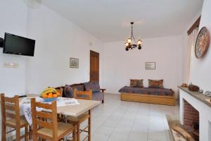 a living room with a table and a couch at House Katia in Kalamos