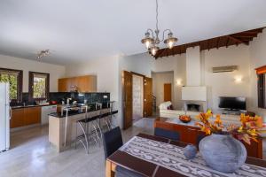 a kitchen and living room with a table and a vase at Villa Oleander in Kouklia