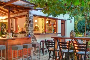 a bar with chairs and a counter in a restaurant at House Katia in Kalamos