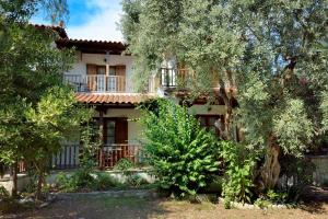 a large house with trees in front of it at House Katia in Kalamos