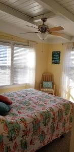 a bedroom with a bed and a ceiling fan at donovan"s Reef in Oak Island