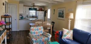 a living room with a couch and a kitchen at donovan"s Reef in Oak Island +14 photos