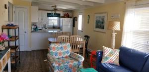 a living room with a couch and a kitchen at donovan"s Reef in Oak Island