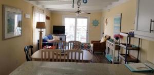 a kitchen and living room with a table and chairs at donovan"s Reef in Oak Island