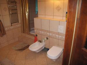 a bathroom with a toilet and a bidet at Szypry - wakacyjny dom nad jeziorem in Barczewo +23 photos