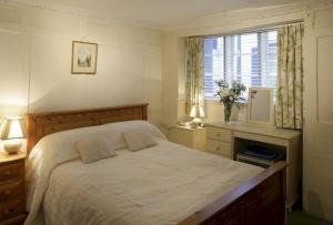 a bedroom with a large bed and a window at Bath Place Hotel in Oxford