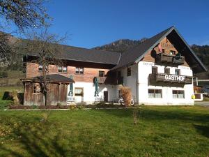 a large white building with a black roof at Gasthof Gruber in Wald am Schoberpaß