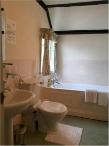 a bathroom with a toilet and a sink and a tub at Bath Place Hotel in Oxford