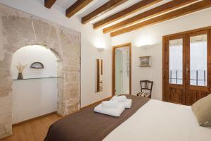 A bed or beds in a room at Ramón Llull House