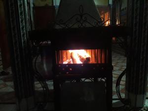 a fire in a stove in a room at Hotel Anaia in Chefchaouene