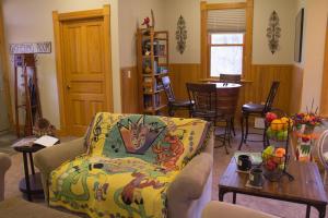 a living room with a couch and a table at Pinehurst Inn Bed & Breakfast in Bayfield
