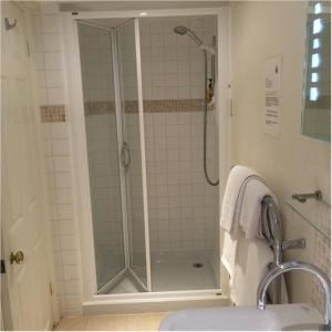 a shower in a bathroom with a sink and a shower at Bath Place Hotel in Oxford