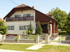 a house with a fence in front of it at Zsuzsi Apartman in Zalakaros