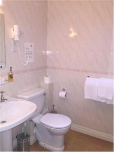 a bathroom with a white toilet and a sink at Bath Place Hotel in Oxford