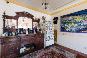 a kitchen with a refrigerator and a painting on the wall at The Hostel California in Bishop