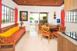 a living room with a couch and a table at Sunset Gardens in Olón