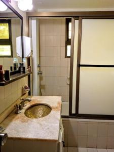 a bathroom with a sink and a shower at Tejas Verdes Alojamiento Familiar in Villa Gesell +13 photos