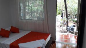 a bedroom with a bed and a zebra outside a door at Hostal Villa Cecilia in Villavieja