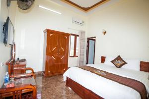 מיטה או מיטות בחדר ב-Ngoc Lan Hotel