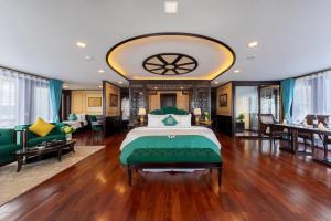 a bedroom with a bed and a living room at La Regina Legend Cruise in Ha Long