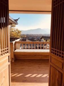 a view from an open door of a balcony at Jianshe Inn in Lijiang
