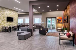 a lobby of a hospital with chairs and tables at Best Western Plus Temecula Wine Country Hotel & Suites in Temecula