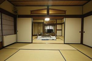a room with doors and a bed in it at Yamadaya Ryokan in Nozawa Onsen
