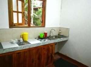 a kitchen counter with a sink and a window at Coco Garden Holiday Homes in Anuradhapura