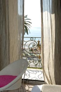 a room with a view of the ocean from a balcony at Hôtel Le Royal Promenade des Anglais in Nice