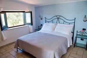 Ένα ή περισσότερα κρεβάτια σε δωμάτιο στο B&B Baia Di Trentova