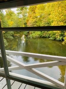 a view of a river from a window at Maison d'Hôtes Moulin Saint Julien in Olivet